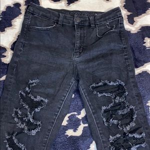 Woman’s black distressed jeans
